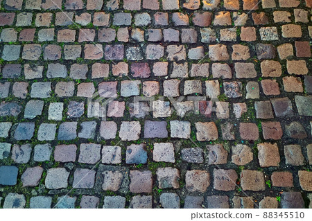 The background is made of old paving stones in the old part of the city, the texture of the stone. The background is made of old paving stones in the old part of the city, the texture of the stone. 88345510