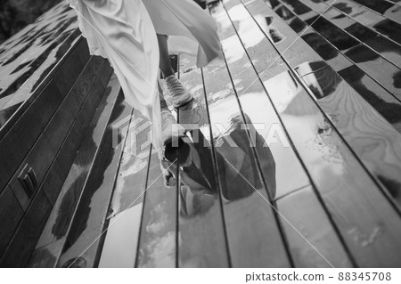 girl white dress runs wet wooden floor 88345708