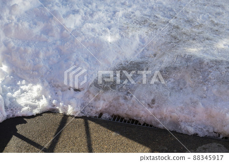 The road where snow was removed and asphalt appeared 88345917