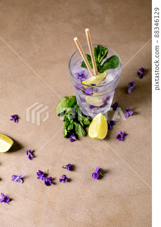 Glass of lemonade cocktail with violets flowers 88346129