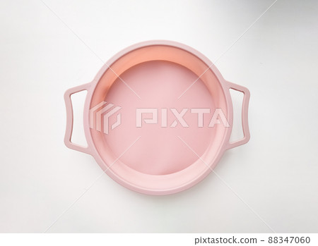 New round silicone baking dish with handles isolated on white background.  88347060
