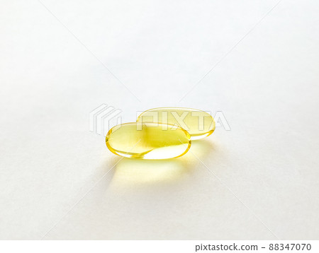 Closed capsules with dietary supplement: fish oil, omega 3, vitamin A, vitamin D3, vitamin E. Selective focus 88347070