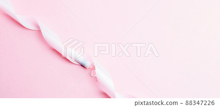 Menstrual tampon feminine hygiene. Pink ribbon with menstrual tampon on pink background. Menstruation feminine period. Sanitary hygiene concept. Medical healthcare gynecological banner. 88347226