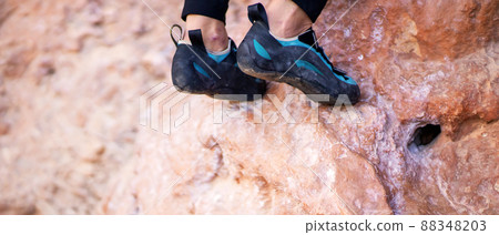 Feet with climbing shoes on the rocks closeup. Feet with climbing shoes on the rocks closeup. 88348203