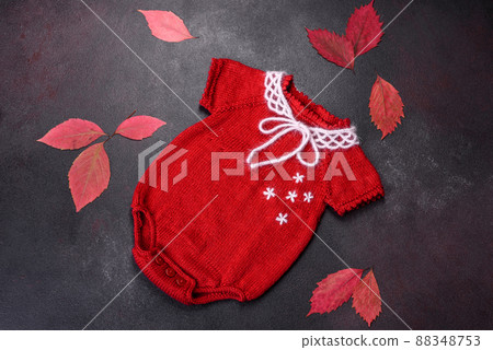Clothing for a newborn baby knitted from red threads 88348753