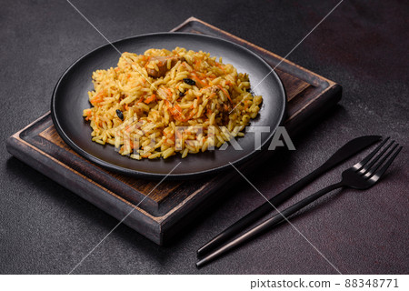 Pilaf or pilau with chicken, traditional uzbek hot dish of boiled rice, chicken meat, vegetables and spices Pilaf or pilau with chicken, traditional uzbek hot dish of boiled rice, chicken meat, vegetables and spices 88348771