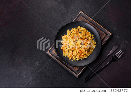 Pilaf or pilau with chicken, traditional uzbek hot dish of boiled rice, chicken meat, vegetables and spices Pilaf or pilau with chicken, traditional uzbek hot dish of boiled rice, chicken meat, vegetables and spices 88348772