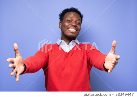 Cheerfull african man wanting to cuddle, smiling broadly Cheerfull african man wanting to cuddle, smiling broadly 88349447
