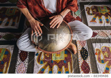 Close-up of a man's hand playing a modern musical instrument, the orion reed drum 88349486
