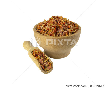 dried carrot pieces in wooden bowl and scoop isolated on white background. Spices and food ingredients. dried carrot pieces in wooden bowl and scoop isolated on white background. Spices and food ingredients. 88349604
