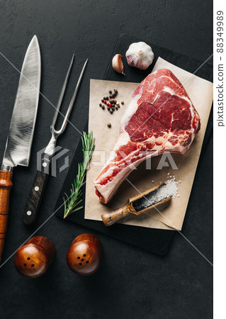 Raw cowboy steak and spices flat lay. BBQ top view 88349989