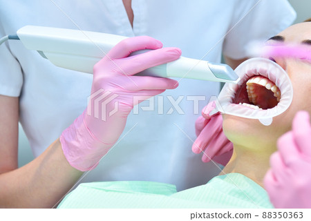 Dentist scaning patient's teeth with intraoral 3d scanner Dentist scaning patient's teeth with intraoral 3d scanner 88350363