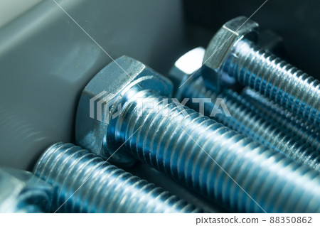 Large mounting bolts. New fasteners in the tool box. Metal bolt close-up. Selective focus 88350862