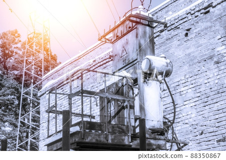 Old high-voltage transformer of city power supply. Rusty equipment of the power plant. Selective focus Old high-voltage transformer of city power supply. Rusty equipment of the power plant. Selective focus 88350867