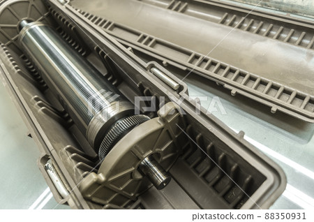 Used magnetic cylinder for rotary printing machine in plastic box. Magnetic shaft for die mounting. Selective focus 88350931