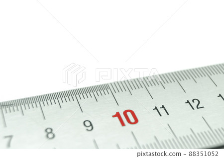 Iron ruler close-up on a white background. Stainless steel ruler. Working tools made of metal and stationery. Selective focus, isolated on white Iron ruler close-up on a white background. Stainless steel ruler. Working tools made of metal and stationery. Selective focus, isolated on white 88351052
