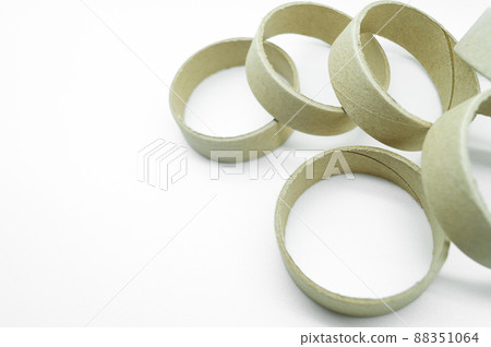Narrow cardboard spools for winding rolled materials and self-adhesive labels. Reels made of cardboard for printing houses. Selective focus, isolated on white Narrow cardboard spools for winding rolled materials and self-adhesive labels. Reels made of cardboard for printing houses. Selective focus, isolated on white 88351064