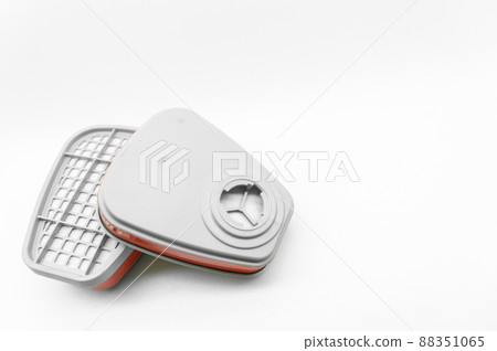 A pair of filters for the respirator. Replaceable cartridges of a protective mask for cleaning polluted air. Selective focus, isolated on white A pair of filters for the respirator. Replaceable cartridges of a protective mask for cleaning polluted air. Selective focus, isolated on white 88351065