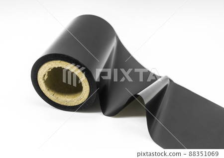 Black thermal transfer ribbon - TTR. Wax thermo ribbon on cardboard reel for barcode. Supply material for printing industry. Selective focus, isolated on white Black thermal transfer ribbon - TTR. Wax thermo ribbon on cardboard reel for barcode. Supply material for printing industry. Selective focus, isolated on white 88351069