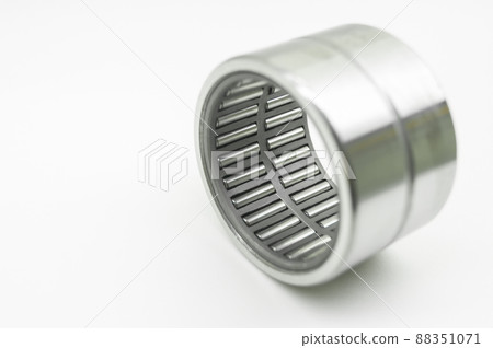Needle bearing on a white background. Roller bearing for motors, machinery and equipment. Spare part. Selective focus, isolated on white 88351071