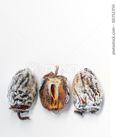 Dried persimmon on a white background. Healthy diet Dried persimmon on a white background. Healthy diet 88352350