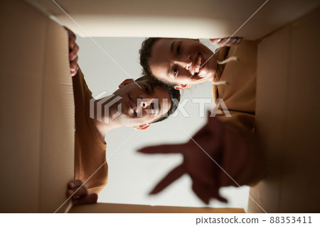 Couple Unpacking In New Apartment Couple Unpacking In New Apartment 88353411