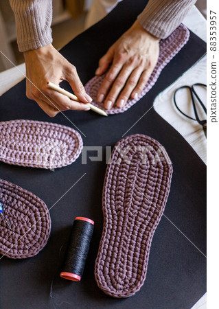 Female knitted clothes and shoes designer sketching drawing sample domestic slippers sole on fabric 88353957