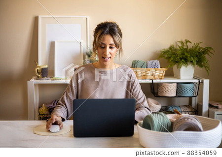 Portrait woman knitted clothes accessories designer laptop creating pattern or digital marketing Portrait woman knitted clothes accessories designer laptop creating pattern or digital marketing 88354059