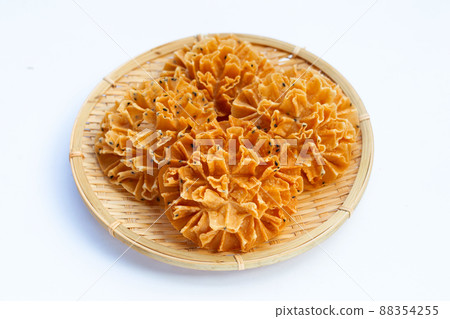 Crispy lotus blossom cookie on white background. Crispy lotus blossom cookie on white background. 88354255