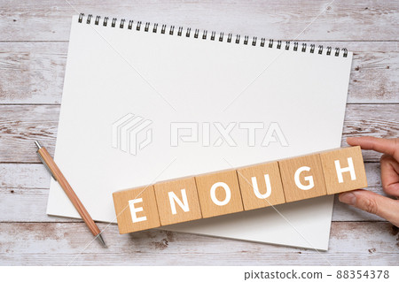 Blocks, notebooks, pens, hands labeled "ENOUGH" Blocks, notebooks, pens, hands labeled "ENOUGH" 88354378