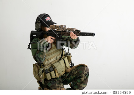 Female soldier holding a gun Female soldier holding a gun 88354599