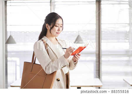 Check notes Asian business woman Check notes Asian business woman 88355816