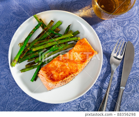Roasted salmon steak and green asparagus on plate Roasted salmon steak and green asparagus on plate 88356298