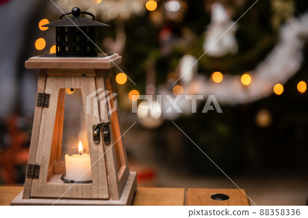 A candle burns closed inside a decorative lantern on Christmas Day. A candle burns closed inside a decorative lantern on Christmas Day. 88358336