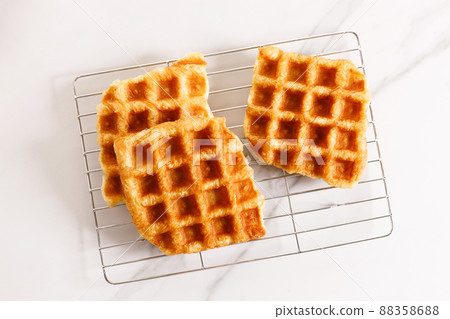 Croissant waffle or Croffle on  cooling rack. 88358688