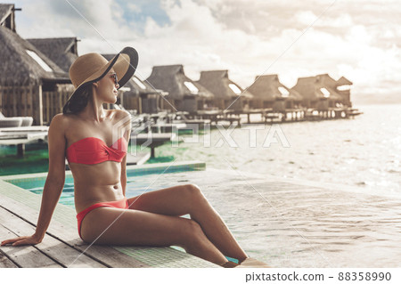 Suntan bikini body Asian woman relaxing Stock Photo 88358990