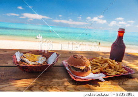 Beach fast food restaurant shake shack bar view of burger and french fries on table with view of ocean in Bora Bora, Tahiti. Polynesia island travel 88358993