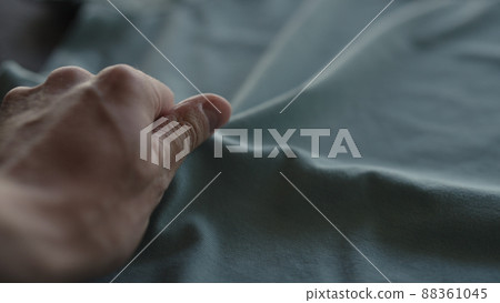 man hand touching blue cotton fabric man hand touching blue cotton fabric 88361045