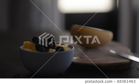 white yogurt in bowl with mango and blueberries 88361463