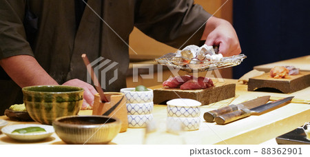 Chef burning tuna fish with hot charcoal. Enjoy Omakase experience at Japanese Sushi Restaurant. Chef burning tuna fish with hot charcoal. Enjoy Omakase experience at Japanese Sushi Restaurant. 88362901
