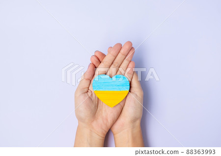 Support for Ukraine in the war with Russia, Hands holding symbol of Heart with flag of Ukraine. Pray, No war, stop war and  stand with Ukraine 88363993