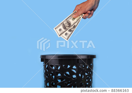 Dollars are thrown into the trash can. Dollars are thrown into the trash can. 88366163
