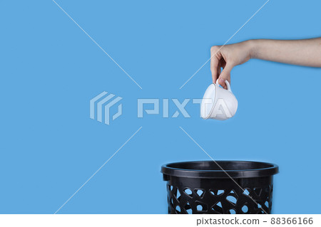 White porcelain cup is thrown into a bucket White porcelain cup is thrown into a bucket 88366166
