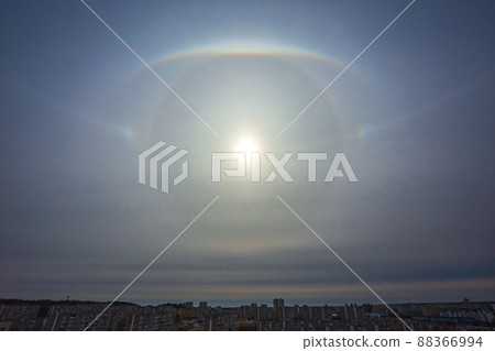 Very rare atmospheric phenomenon called sun halo, Various sun halos arc appearing in the sky in the city 88366994