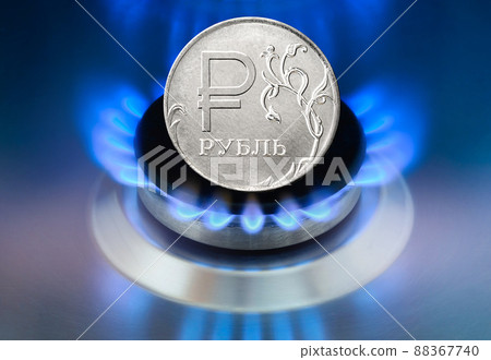 Concept of Russia sanctions of gas payment. Russian Ruble coin and Gas burning in the home stove 88367740
