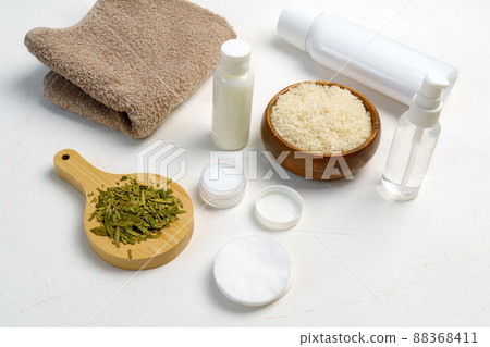 Skin care, a mock-up of a bottle with a dispenser, rice and green tea, the concept of fermented beauty care. Flat lay Skin care, a mock-up of a bottle with a dispenser, rice and green tea, the concept of fermented beauty care. Flat lay 88368411