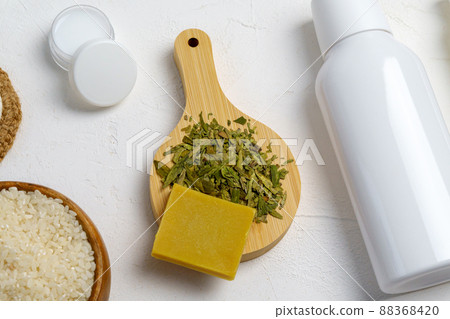 Skin care, a mock-up of a bottle with a dispenser, rice and green tea, the concept of fermented beauty care. Skin care, a mock-up of a bottle with a dispenser, rice and green tea, the concept of fermented beauty care. 88368420