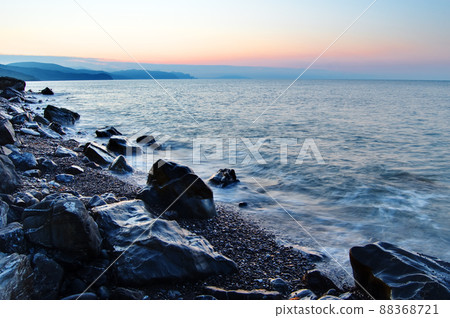 Sunset on the black sea. Beautiful clouds, blue sky, sun on the horizon. Beautiful stones in the foreground Sunset on the black sea. Beautiful clouds, blue sky, sun on the horizon. Beautiful stones in the foreground 88368721