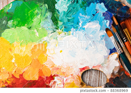art palette with colorful mixed paints 88368969