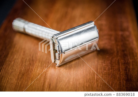 Old vintage shaver on a wooden background Old vintage shaver on a wooden background 88369018